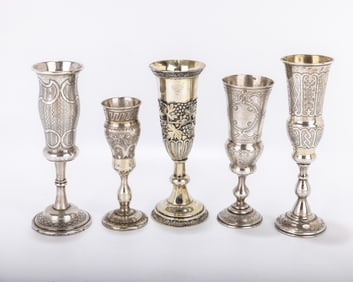 A GROUP OF FIVE SILVER CHAMPAGNE FLUTES. On round stems  with a bright cut engine turned engraving