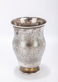 A HIGHLY ENGRAVED SILVER BEAKER. Russia, 1858. On a round base with a large baluster shaped body.