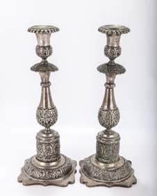 A MONUMENTAL PAIR OF SILVER SABBATH CANDLESTICKS. Russian, 1881. On stylized flat square bases with