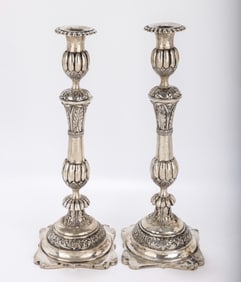 A MONUMENTAL PAIR OF SILVER SABBATH CANDLESTICKS. Zhitomer, 1884. On stylized flat square bases with