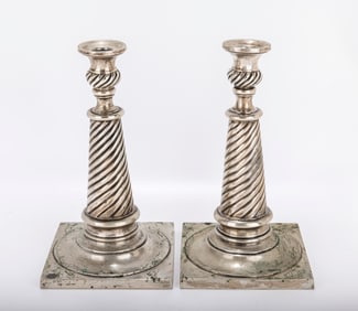 A PAIR OF SOLOMONIC SILVER CANDLESTICKS. Vienna, c. 1900. On large square bases with twisted stems.
