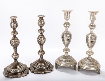 TWO PAIRS OF SILVER SABBATH CANDLESTICKS. Poland and USA, c. 1900. The American pair on flat bases