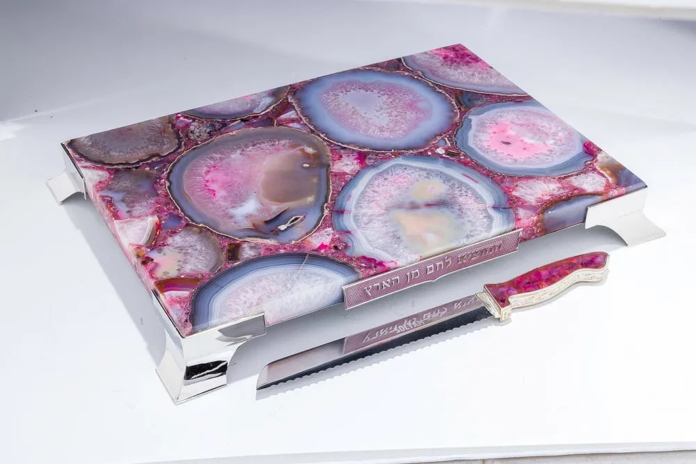 A STERLING SILVER AND COLORED AGATE CHALLAH BOARD BY YAAKOV DAVIDOFF: Israel, modern. Consisting of a polished stone base with sterling silver support frame. Accompanied by a matching high quality sterling and stone handled knife with a heavy steel blade. Fitted in a wo