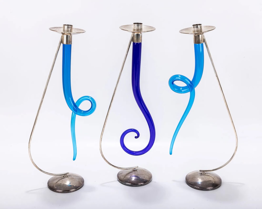 THREE STERLING SILVER AND ITALIAN GLASS CANDLESTICKS. Modern. Each hand blown glass fitted with a st: THREE STERLING SILVER AND ITALIAN GLASS CANDLESTICKS. Modern. Each hand blown glass fitted with a sterling silver stand and bobeche. 15.7" tall.