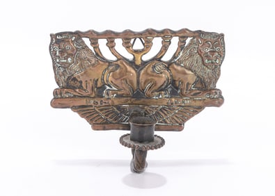 23. AN EARLY BRASS SCONCE BY THE BEZALEL SCHOOL. Jerusalem, c. 1915. Decorated with two outwardly