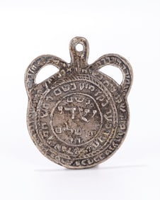 28. A SILVER AMULET. 19th/20th century. Embossed and inscribed with Kabbalistic blessings to ward