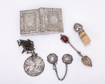 30. A GROUP OF FIVE SMALL SILVER OBJECTS. Including a German wine bottle stopper, a silver binding,