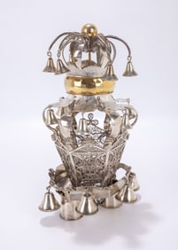 34. A SMALL SILVER TORAH CROWN. Central Europe, late 19th century. On two small staves with filigree