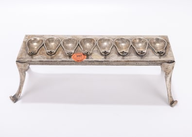 45. A TABLE FORM SILVER HANUKKAH LAMP. Germany, 19th century. On four tall feet that connect to a