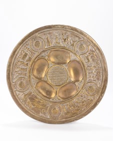 54. . A BRASS SEDER DISH BY BEZALEL. Jerusalem, c. 1930 Stamped with Zev Raban designs. 13' wide.