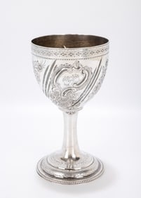 55. AN ORNATE SILVER KIDDUSH GOBLET. Probably the United States, c. 1920. On a beaded round base