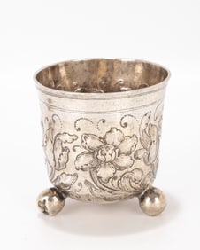 78. AN EARLY SILVER GERMAN BEAKER. Nuremberg, c. 1740. On three balled feet with floral repousee