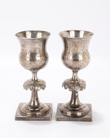 91. A PAIR OF SILVER KIDDUSH GOBLETS. Warsaw, 1867. Each on a square base with a large skirted