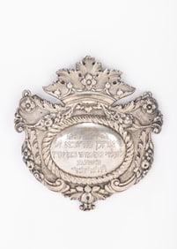 96. A SILVER TORAH SHIELD. Italy, 1869. Hand chased in cartouche form. Engraved THIS WAS DONATED BY