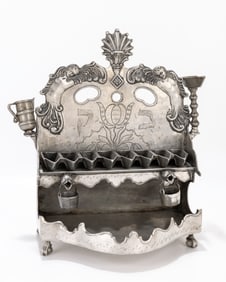 107. .A LARGE PEWTER HANUKKAH LAMP. Germany, 19th century. On four claw supports. The large lower