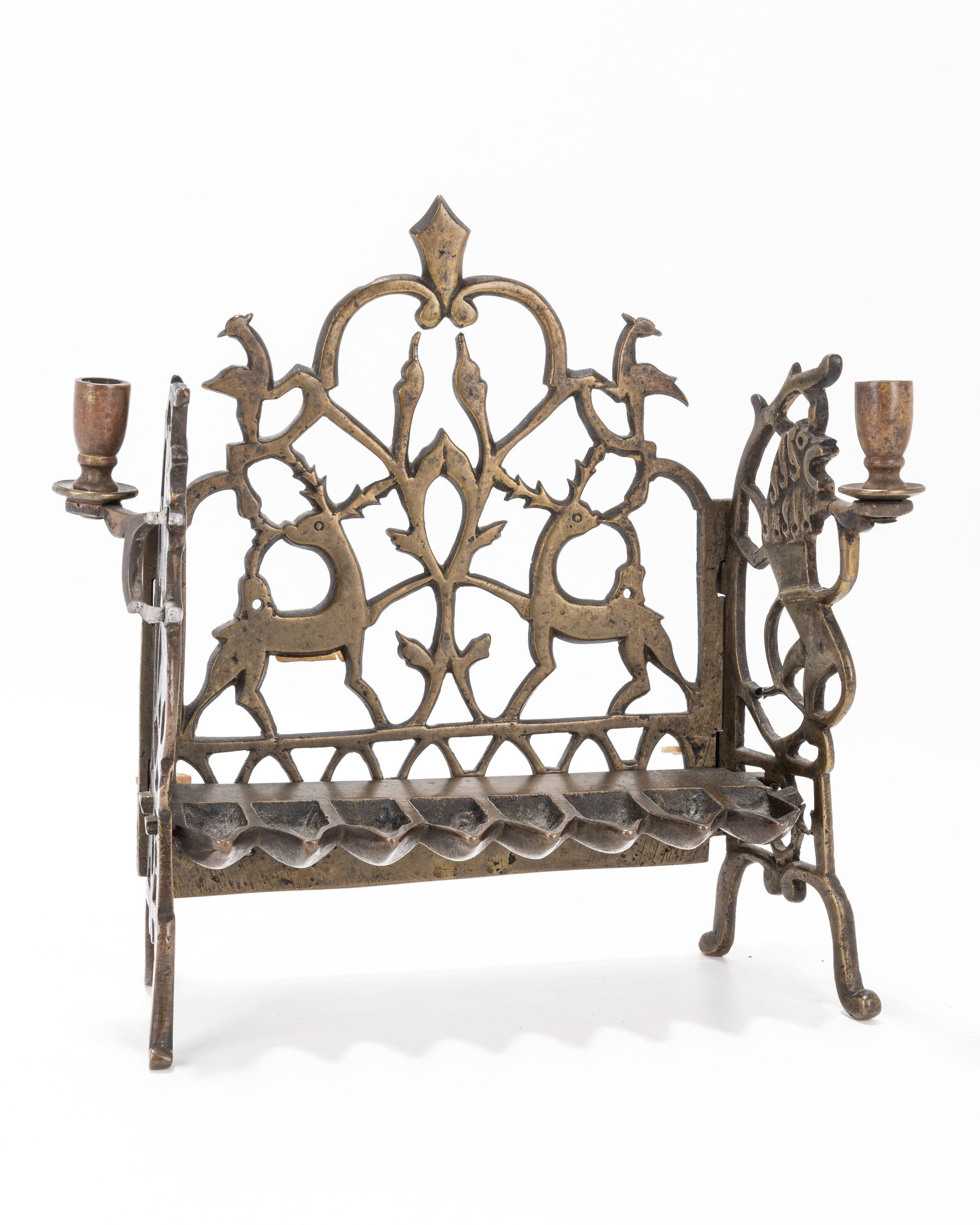 109. A BRASS HANUKKAH LAMP. Poland, 19th century. The back plate is pierced with stags, and floral (1 of 1)