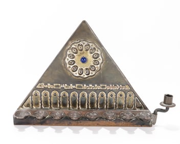 110. AN EARLY BRASS BEZALEL HANUKKAH LAMP. Jerusalem, c. 1910. Triangular in form. Embossed in