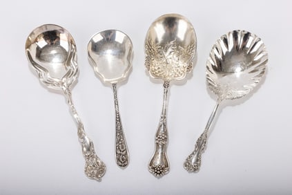 188. A GROUP OF FOUR LARGE AMERICAN STERLING SILVER SERVING SPOONS. The largest is about 9 inches