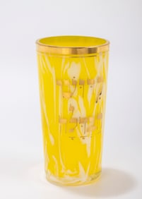 199. A GLASS KIDDUSH BEAKER. Franzenbad, c.1880. Made of yellow carnival glass. With KIDDUSH and