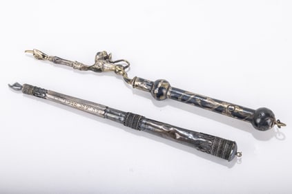 207. TWO SILVER TORAH POINTERS. The first is continental with a lion acting as the first part