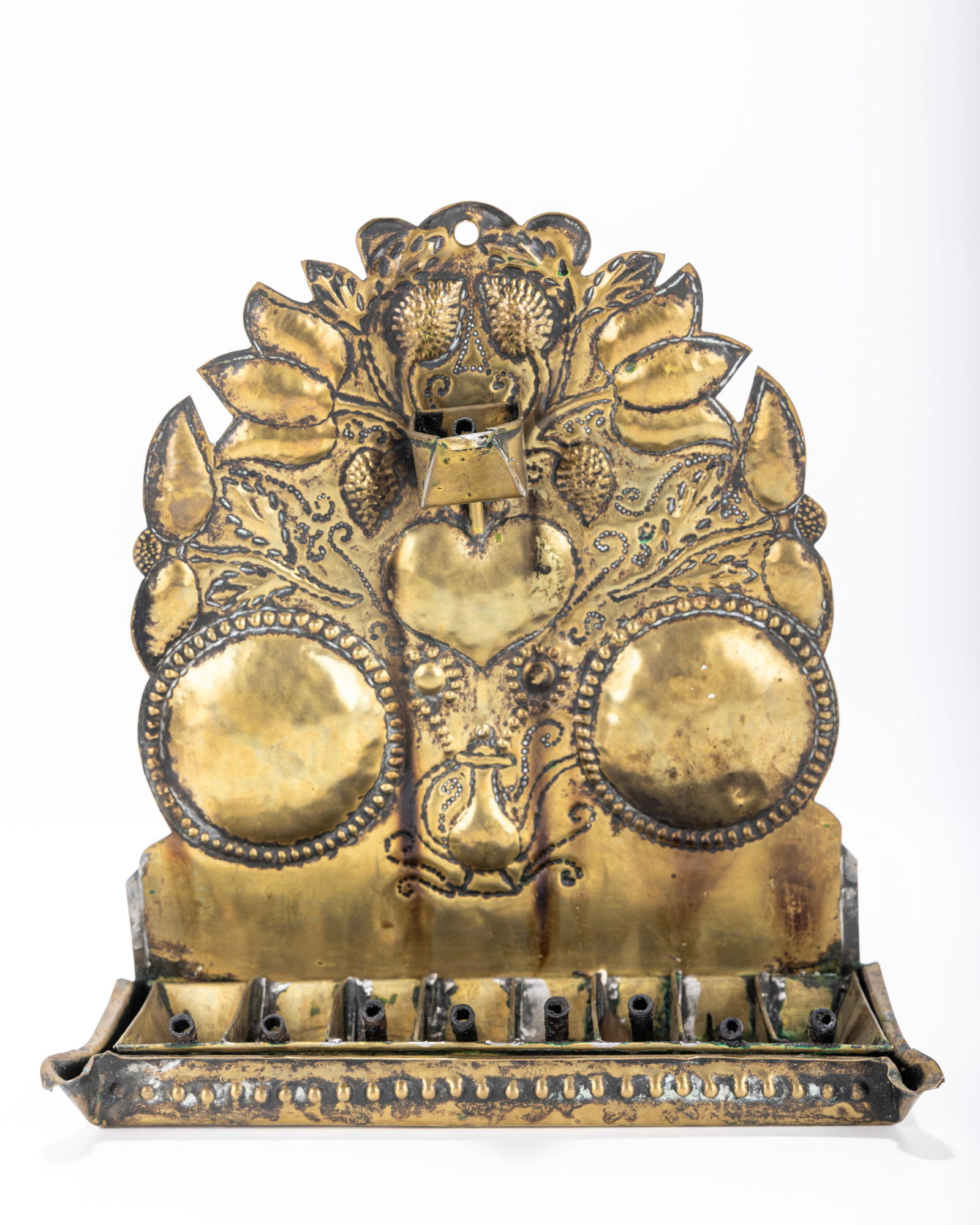 216. A BRASS CHANUKAH LAMP. The Netherlands, 18th century. The back plate is cut with a heart shaped (1 of 1)