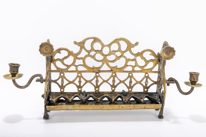 218. A LARGE BRASS HANUKKAH LAMP. Poland, c. 1800. On four feet with back plate decorated scrolling