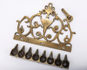 227. A BRASS HANUKKAH LAMP. Greece, 19th century. The backplate with scrolling designs. Inscribed