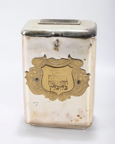 A SILVER PLATED CHARITY BOX. Continental, 20th century. With a handle, a money slot and an applied b