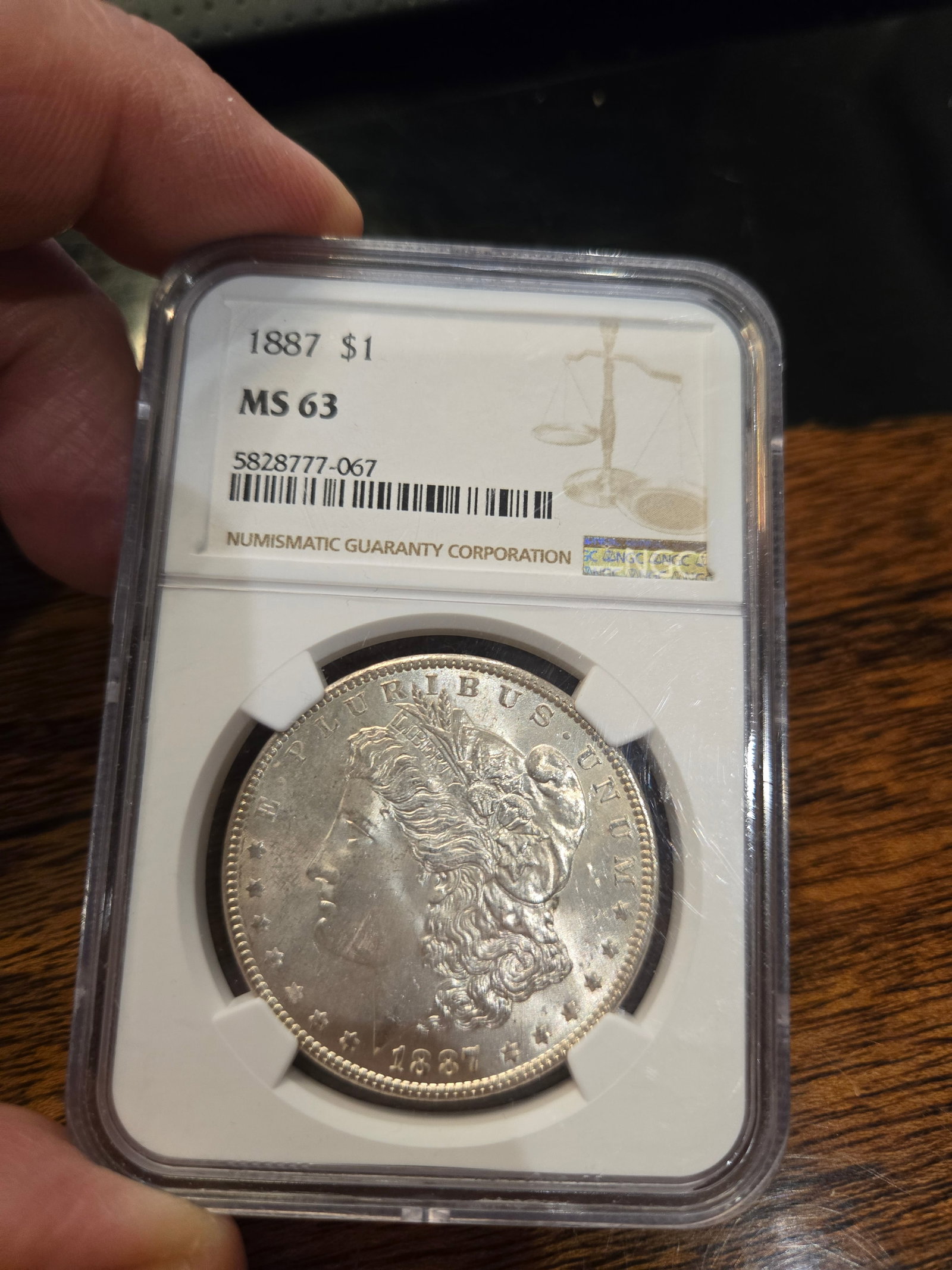 1887 MORGAN SILVER DOLLAR. Graded MS-63. (1 of 2)