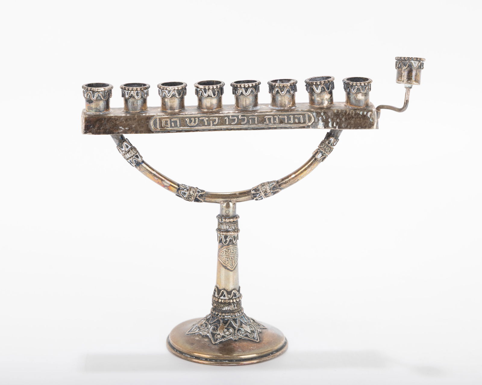 A MINIATURE STERLING SILVER MENORAH BY THE BEZALEL SCHOOL. Jerusalem, c. 1950.