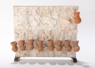 A JERUSALEM STONE AND POTTERY HANUKKAH LAMP.