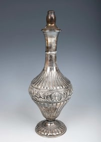 A STERLING SILVER WINE BOTTLE GIVEN BY THE SATMAR REBBETZIN. New York, c.1980.
