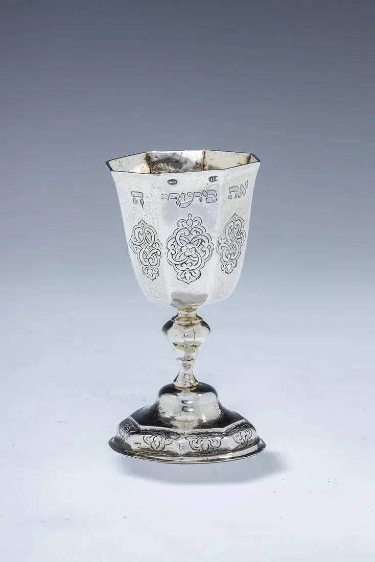 A FINE GERMAN SILVER FESTIVAL GOBLET BY JOHAN JAKOB PRIESTER II. Augsburg, 1741 - 1743.: Augsburg, 1741 - 1743. Parcel gilt. Engraved with a later inscription. Decorated with scroll work foliage and a baluster shaped stem. Repairs. 4.5” tall.