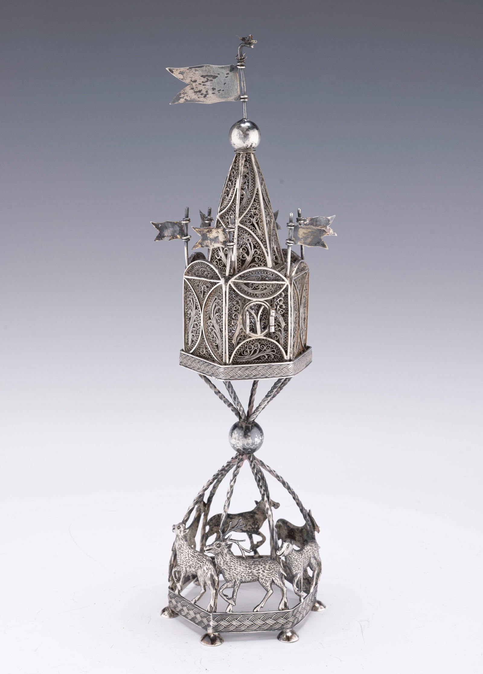 A LARGE SILVER SPICE CONTAINER. Poland, c. 1840.: A LARGE SILVER SPICE CONTAINER. Poland, c. 1840. On a hexagonal base that is fitted with hand wrought and engraved alternating stags and rams that connect to a six sided filigree body fitted with flag