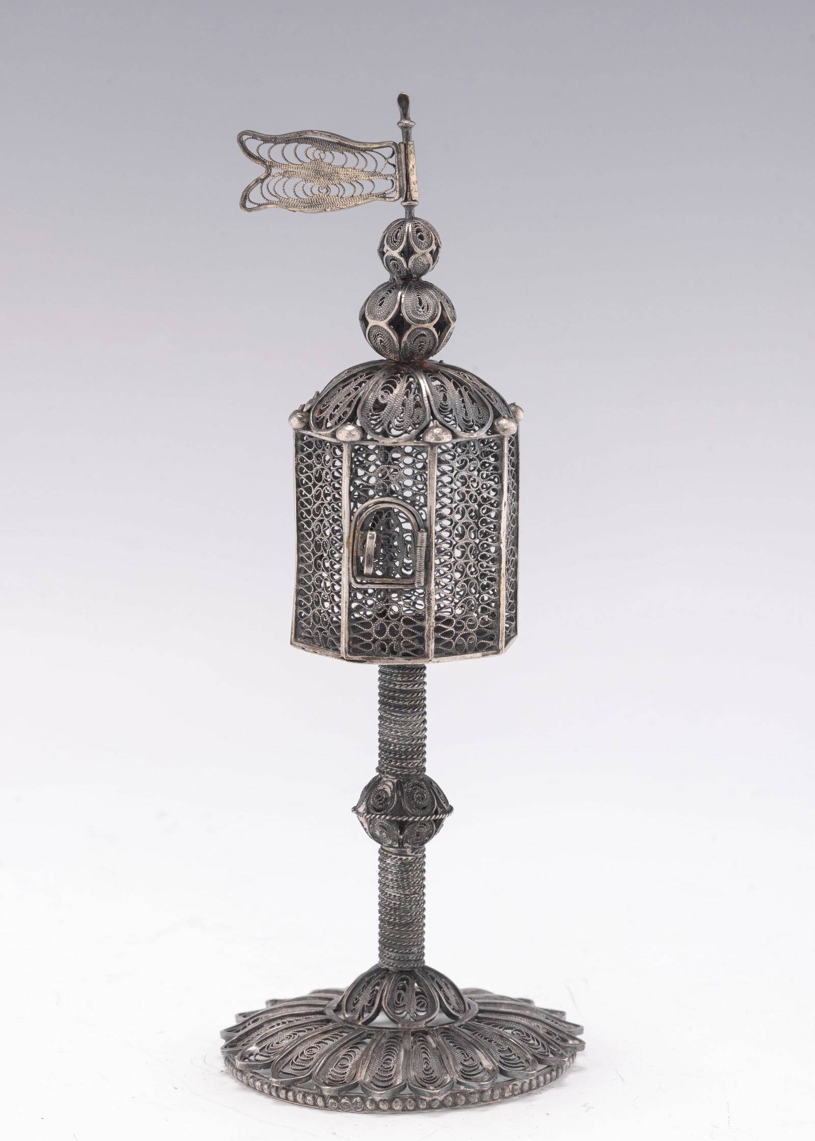 A FILIGREE SPICE TOWER. Continental, first half 20th century.: A SILVER FILIGREE SPICE CONTAINER. Continental, c. 1930. On a round base with a filigree stem and upper portion. 7” tall. Estimate $1,200 - 1,600