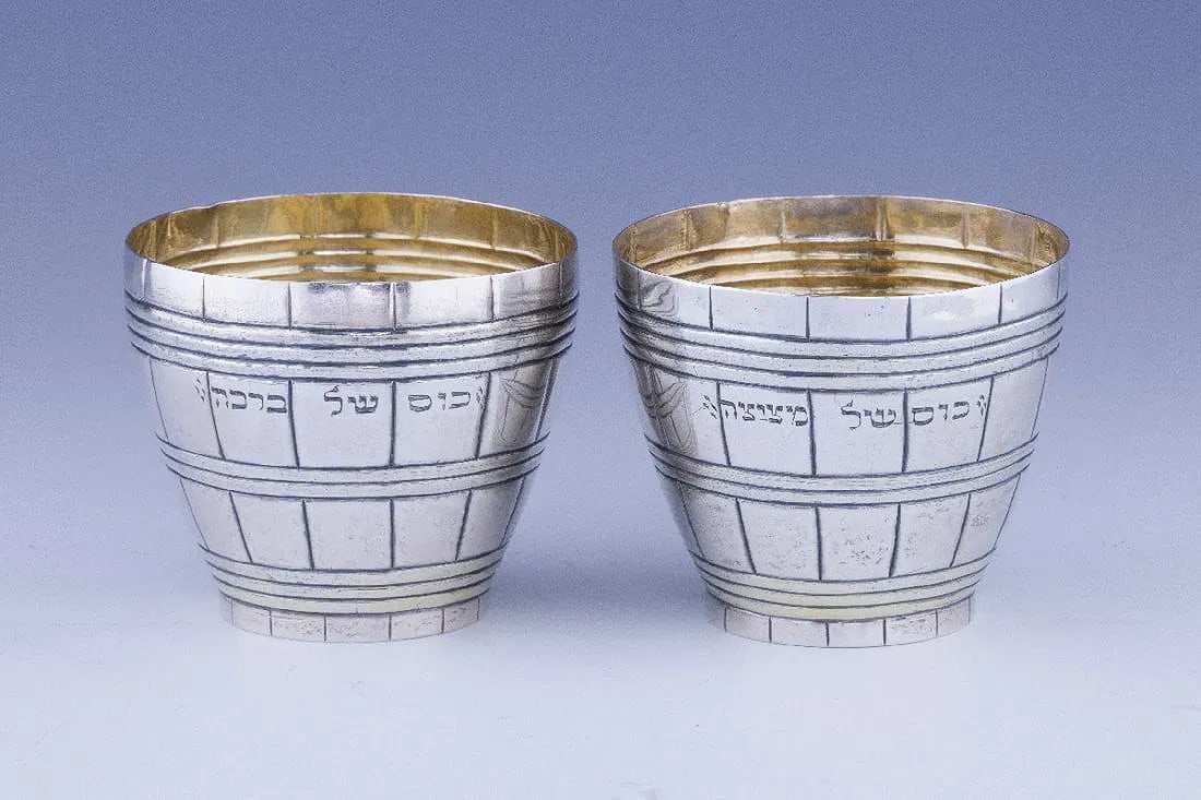 AN EXTREMELY RARE AND LARGE SILVER BARREL FORM BRIS MILAH CUP.: Augsburg, 1784. Barrel form with a large upper and lower portions. The base on both cups, Metzitzah and Bracha are both engraved with the Hebrew letters yud, yud. 4.7'' tall when together and 2.4&rdqu