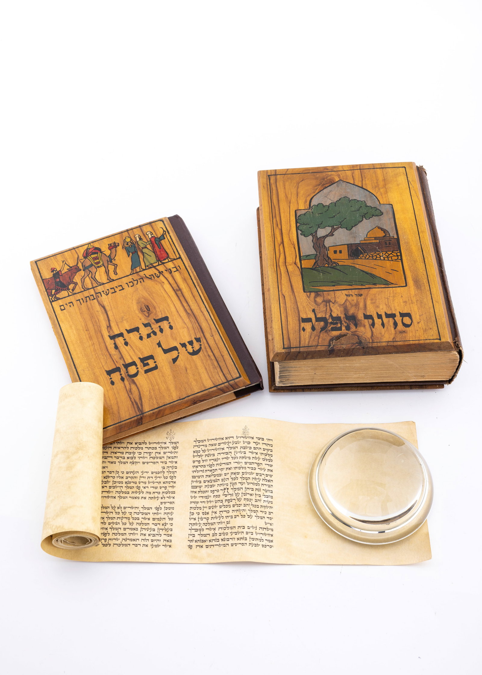AN EARLY BEZALEL SIDDUR AND HAGADDAH.: Jerusalem, c. 1930. Both with olivewood covers, both decorated with colorful decorations. Each approximately 6" tall. Accompanied by a printed copy of Megillat Esther.