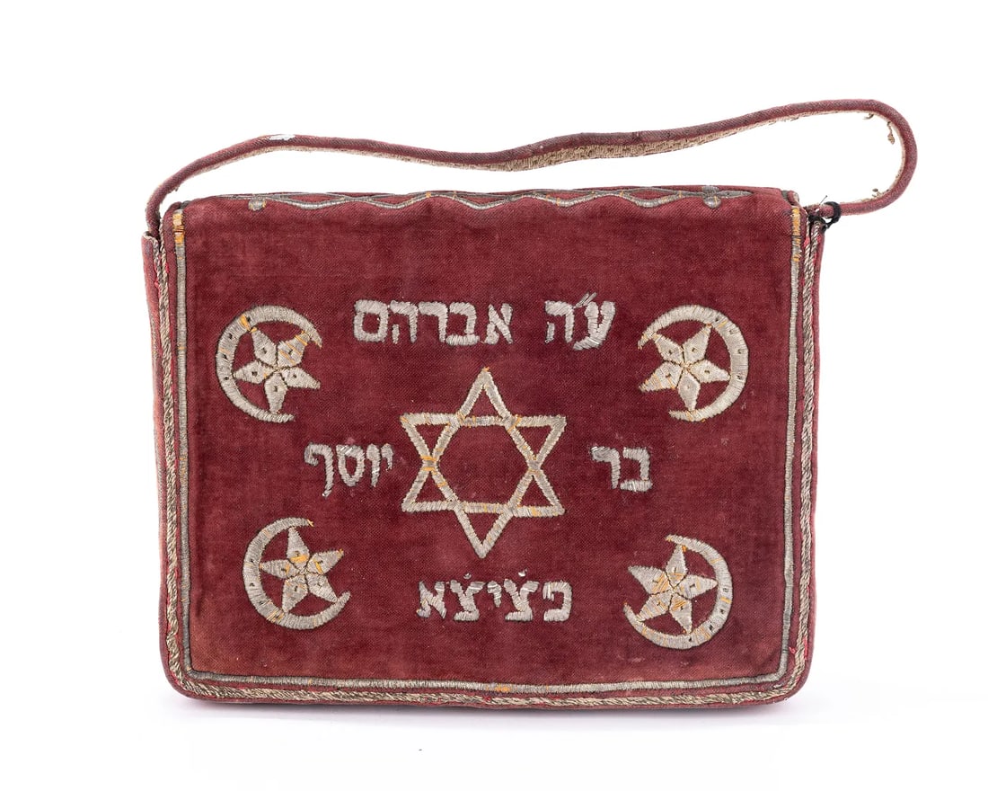 AN EMBRODERED TALLIS BAG. Ottoman Empire, c. 1900.: AN EMBRODERED TALLIS BAG. Ottoman Empire, c. 1900. The body is made of red velvet with gold colored embroidery. The front of the bag is decorated with the image of a rooster with floral designs, Talit