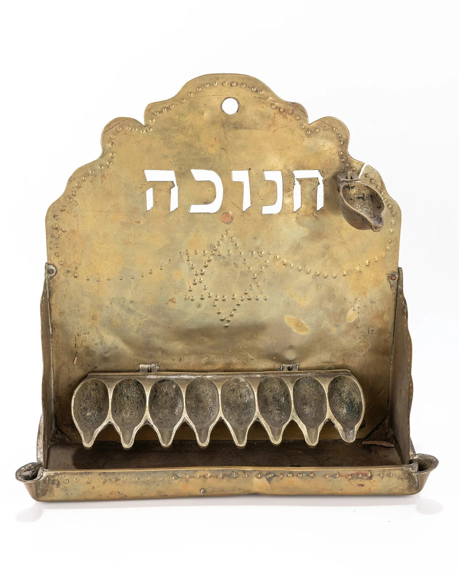 A BRASS HANUKKAH LAMP. The Netherlands, c. 1920: A BRASS HANUKKAH LAMP. The Netherlands, c. 1920. Hand chased and cut brass sheet metal backplate. Chased with period decorations. 10.2" tall.