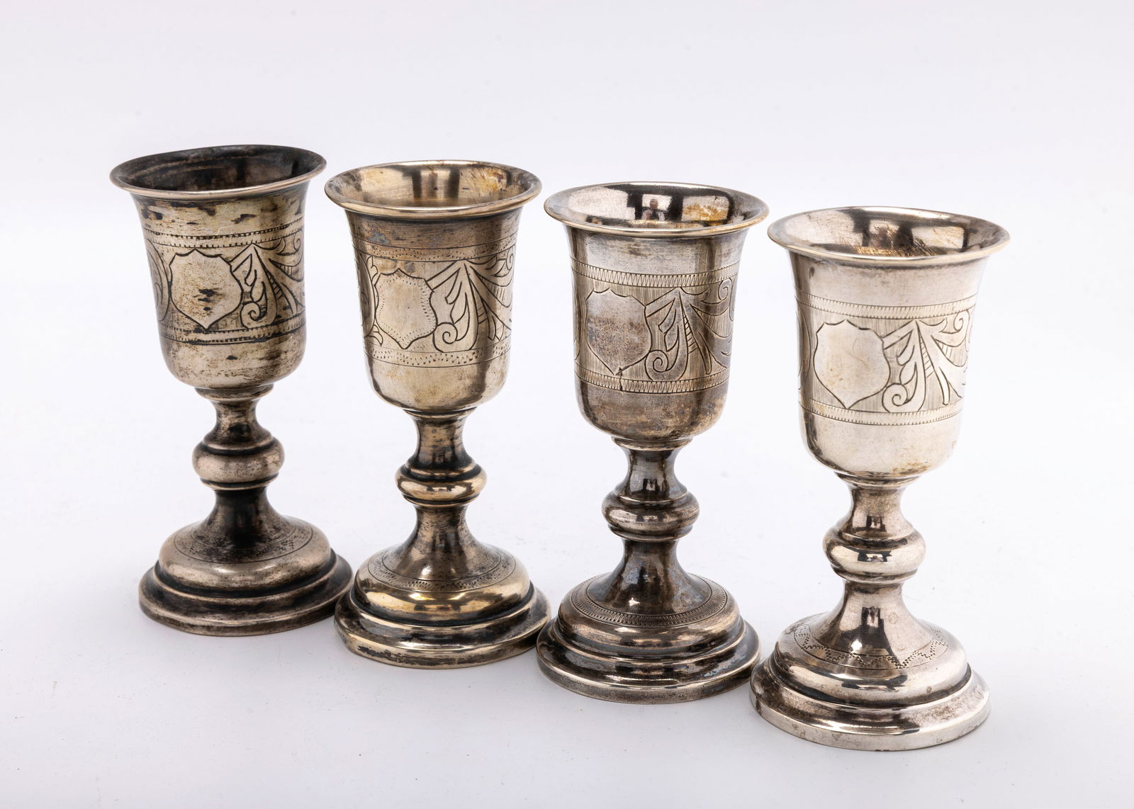 A GROUP OF FOUR SILVER KIDDUSH GOBLETS. Warsaw, c. 1880. (1 of 3)