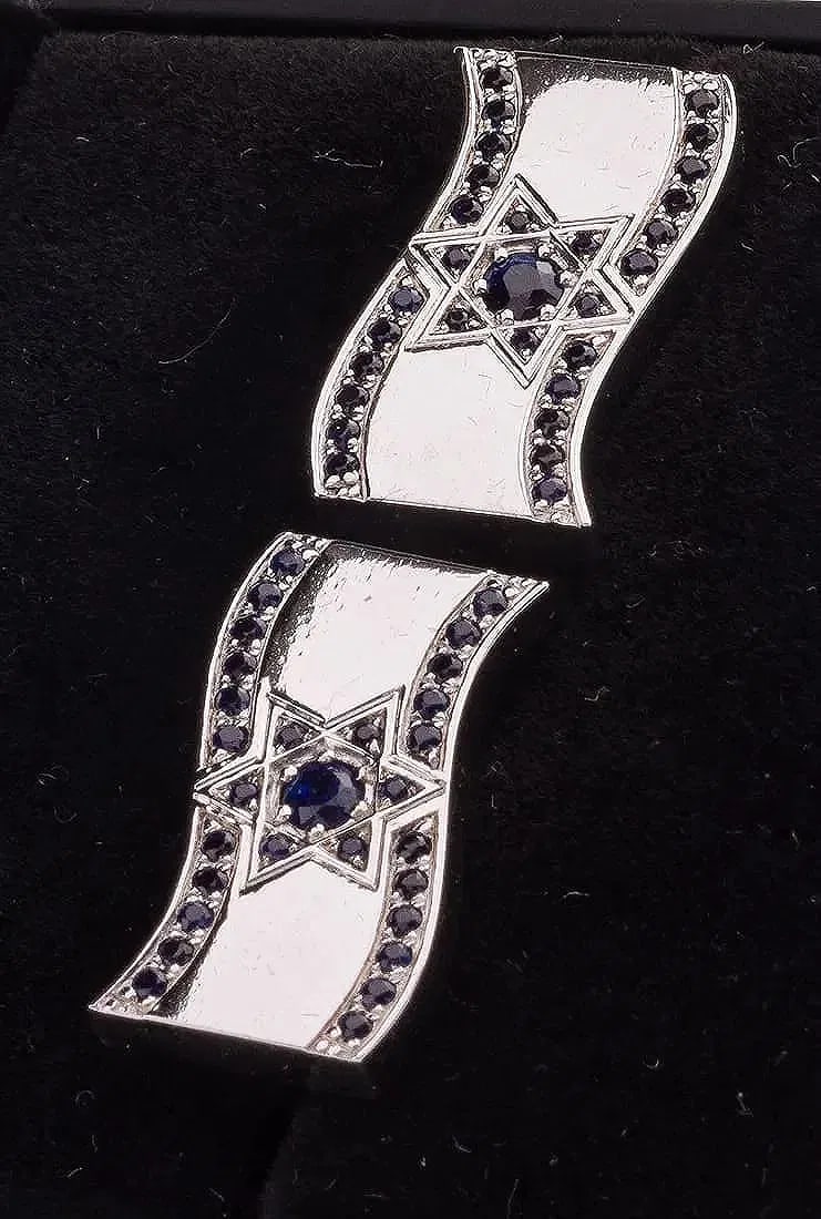 A PAIR OF 14K WHITE GOLD AND SAPPHIRE ISRAELI FLAG OF DAVID CUFFLINKS.: Israel, modern. Decorated with hand cut blue sapphires. 14gms per pair