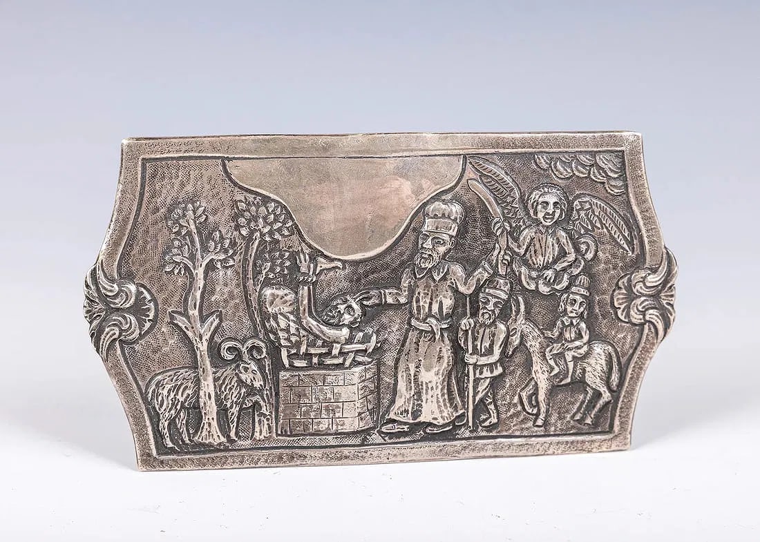 A SILVER BELT BUCKLE FOR YOM KIPPUR. In Polish style. With the scene from the Binding of Isaac. (1 of 3)