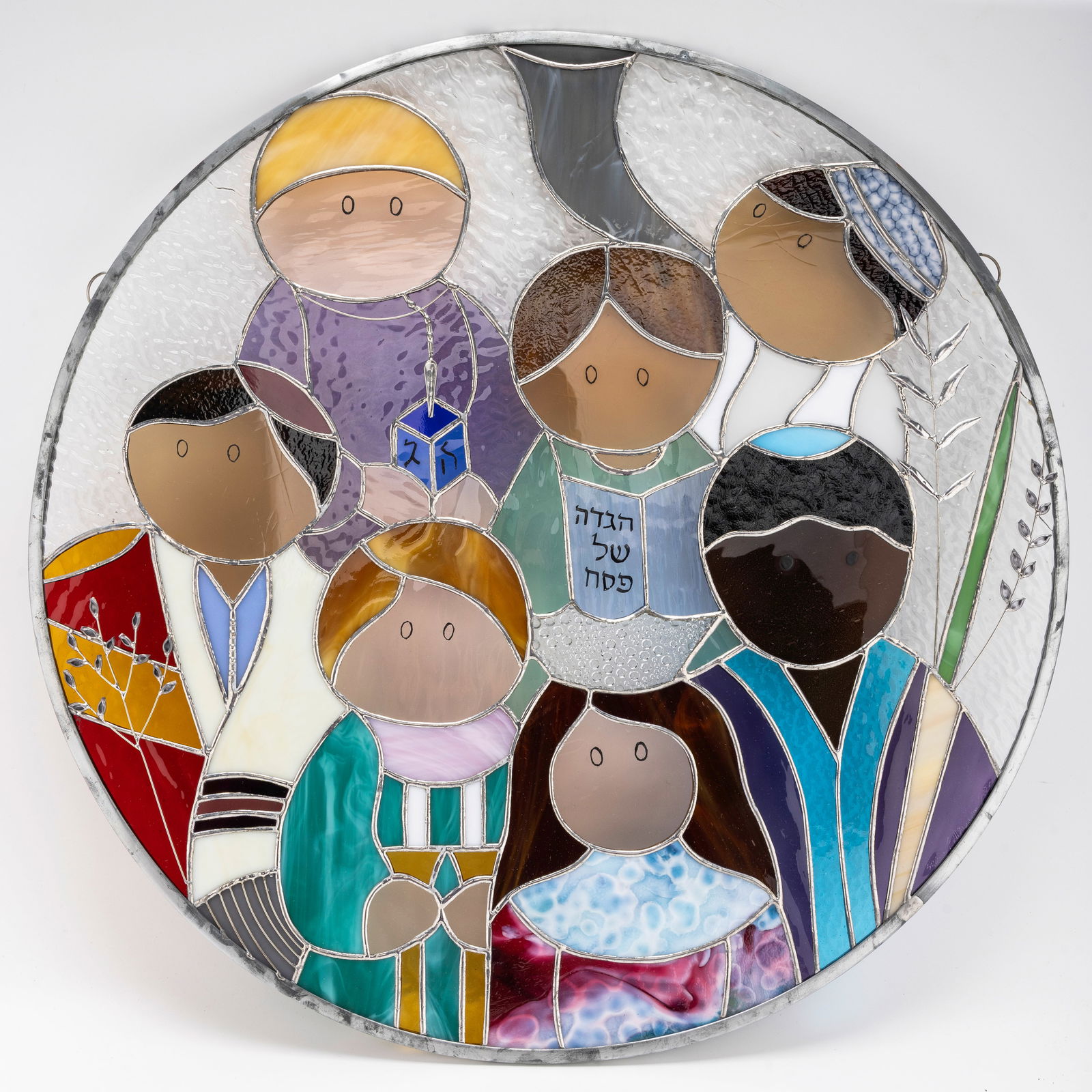 A STAINED GLASS DECORATION CHIILDREN OF THE WORLD BY SUSAN FULLENBAUM: Crafted by BY SUSAN FULLENBAUM . signed and dated 2002. 21" Wide