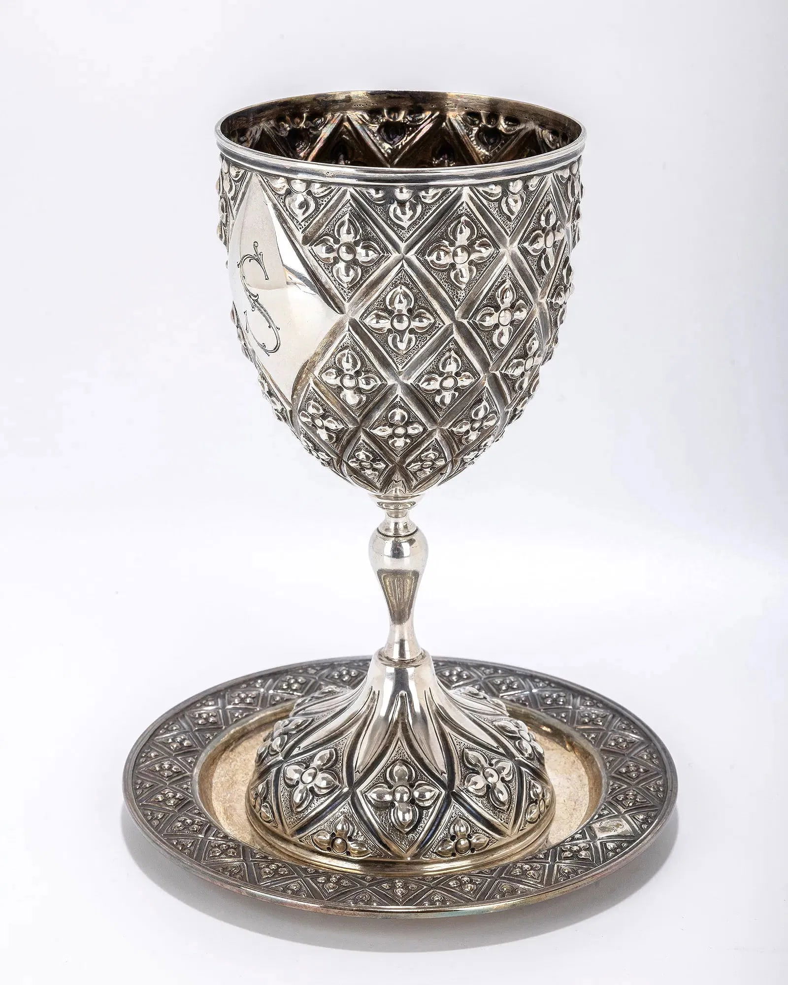 A LARGE STERLING SILVER KIDDUSH CUP BY MARIO BUCCELATI. Italy, c. 1960. Goblet form with an underpl: A LARGE STERLING SILVER KIDDUSH CUP BY MARIO BUCCELATI. Italy, c. 1960. Goblet form with an underplate. Used by the previous Skulener Rebbe, Rabbi Yisroel Avrohom Portugal. Pictured with cup in