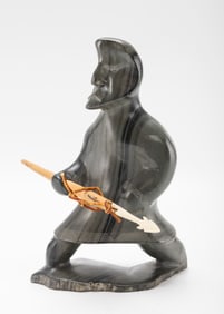 A SOAPSTONE SCULPTURE OF A MAN HUNTING. Possibly a whaler.