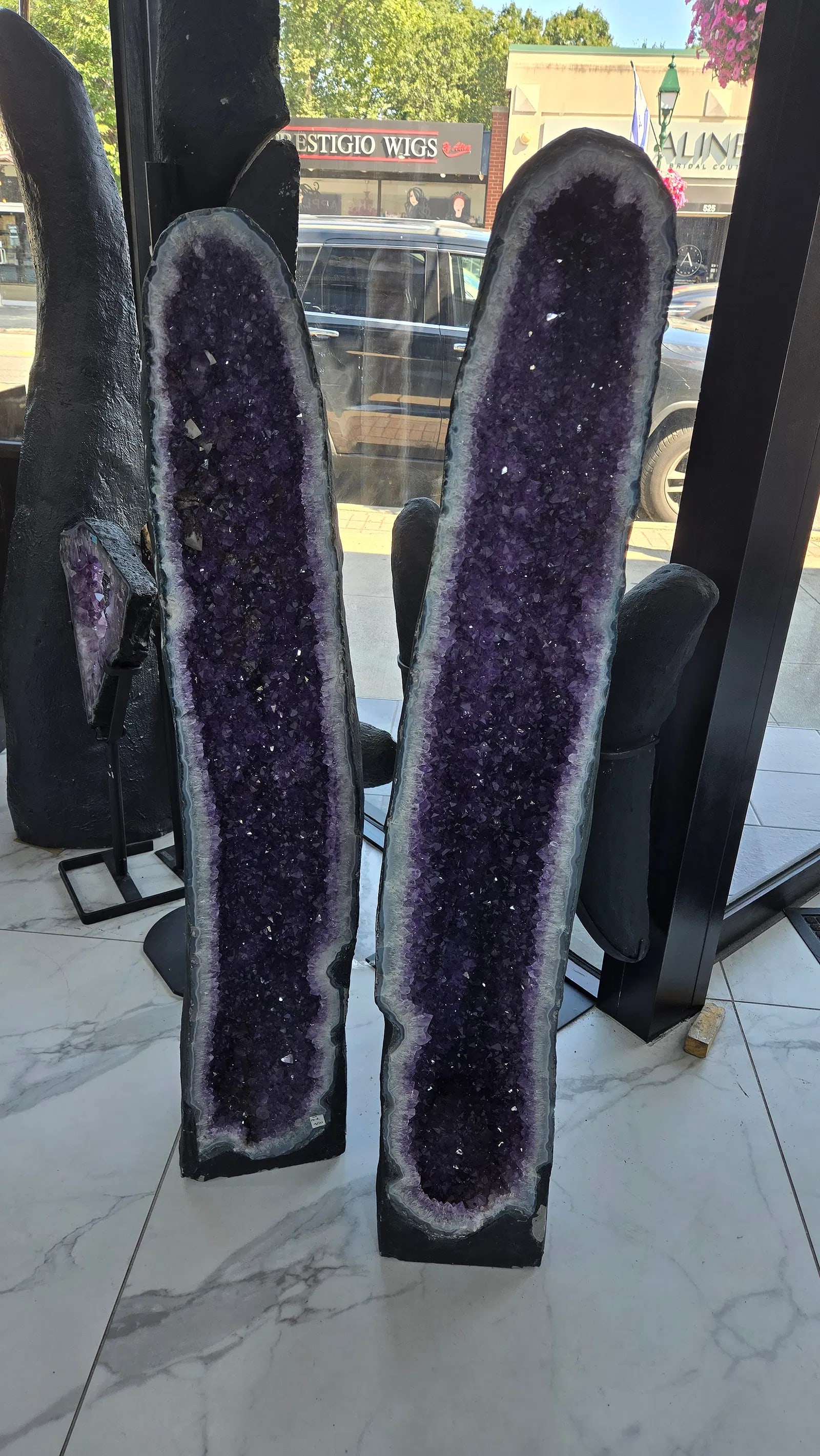 A MASSIVE AND MAGNIFICENT PAIR OF AMETHYST CATHEDRALS: This is a $10,000 set at any gem store. Matching, magnificent amethyst cathedral geode pair. Stunning fluorescent calcite deposits. One was cracked In half and repaired that it is unnoticalble.