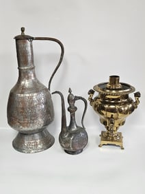 A MASSIVE HAND WROUGHT PITCHER AND AN ARABIC TEA POT