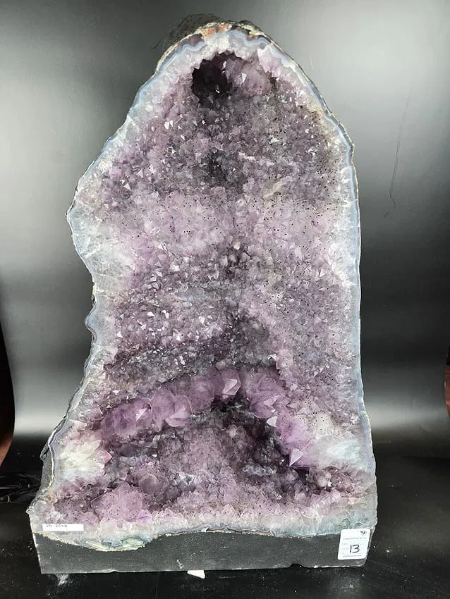 AN AMETHYST GEODE. POLISHED EDGES: 21" TALL X 14" AT IT'S WIDEST 26.2 KILOGRAMS