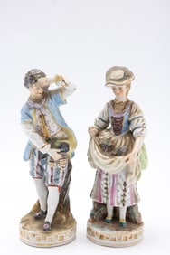 A PAIR OF FIGURINES MADE IN OCCUPIED JAPAN.