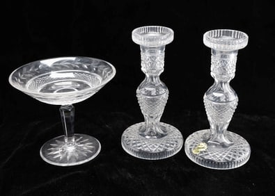 A PAIR OF CRYSTAL CANDLESTICKS AND A COMPOTE.